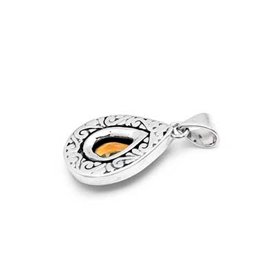 Ciondolo Embun Balinesia, vista 3/4 su sfondo bianco con profilo convesso a goccia in argento 925 ossidato, gancio triangolare e motivi a volute incisi