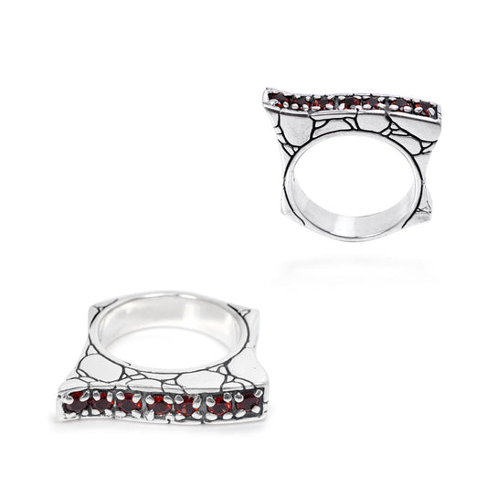 Anello Batu Merah della Collezione Crocodile Balinesia posato su pietra lavica, sfondo giungla tropicale