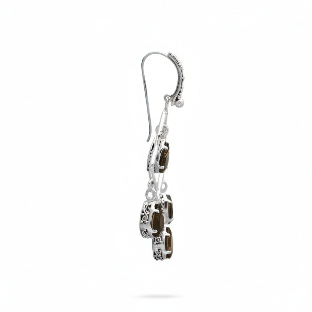 Orecchini Chandelier Quarzo Fumé Balinesia, orecchino singolo su sfondo bianco vista laterale, profilo sottile con gancio francese decorato, montature a griffe ossidato con quarzi fumé pear shape balinesi, Collezione Essenza di Ubud